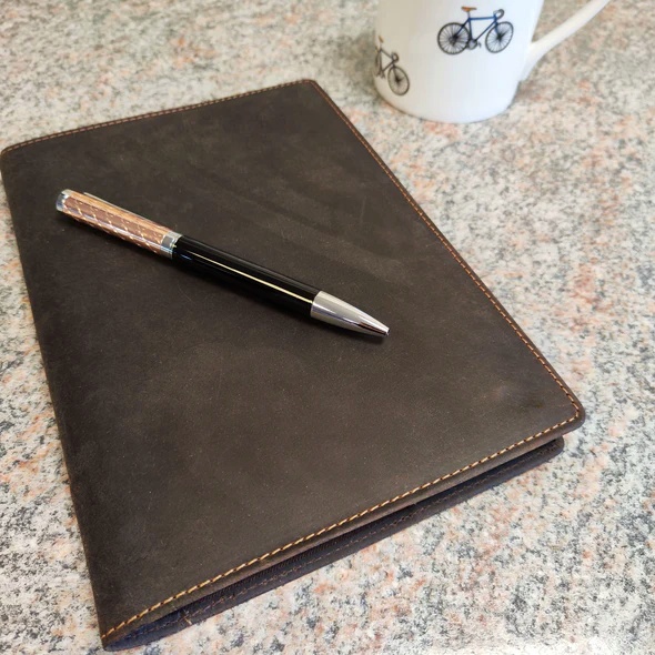 Notebook - A5 Leather Covered, Refillable, in Brown - closed shown with pen