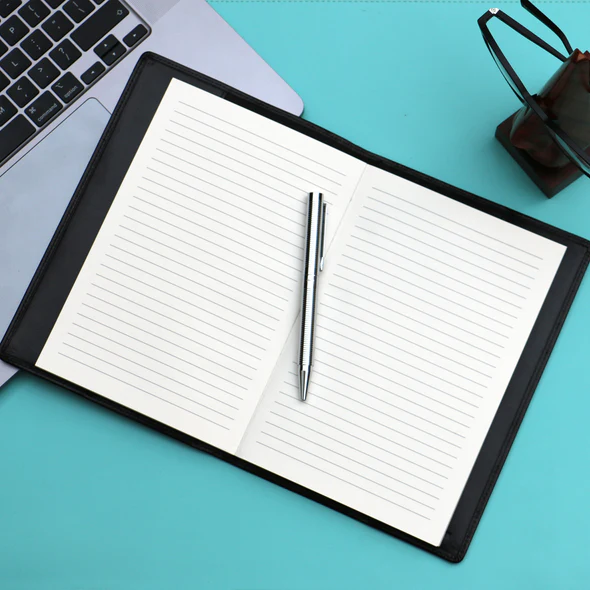 Notebook - A5 Leather Covered, Refillable, in Black - open shown with pen